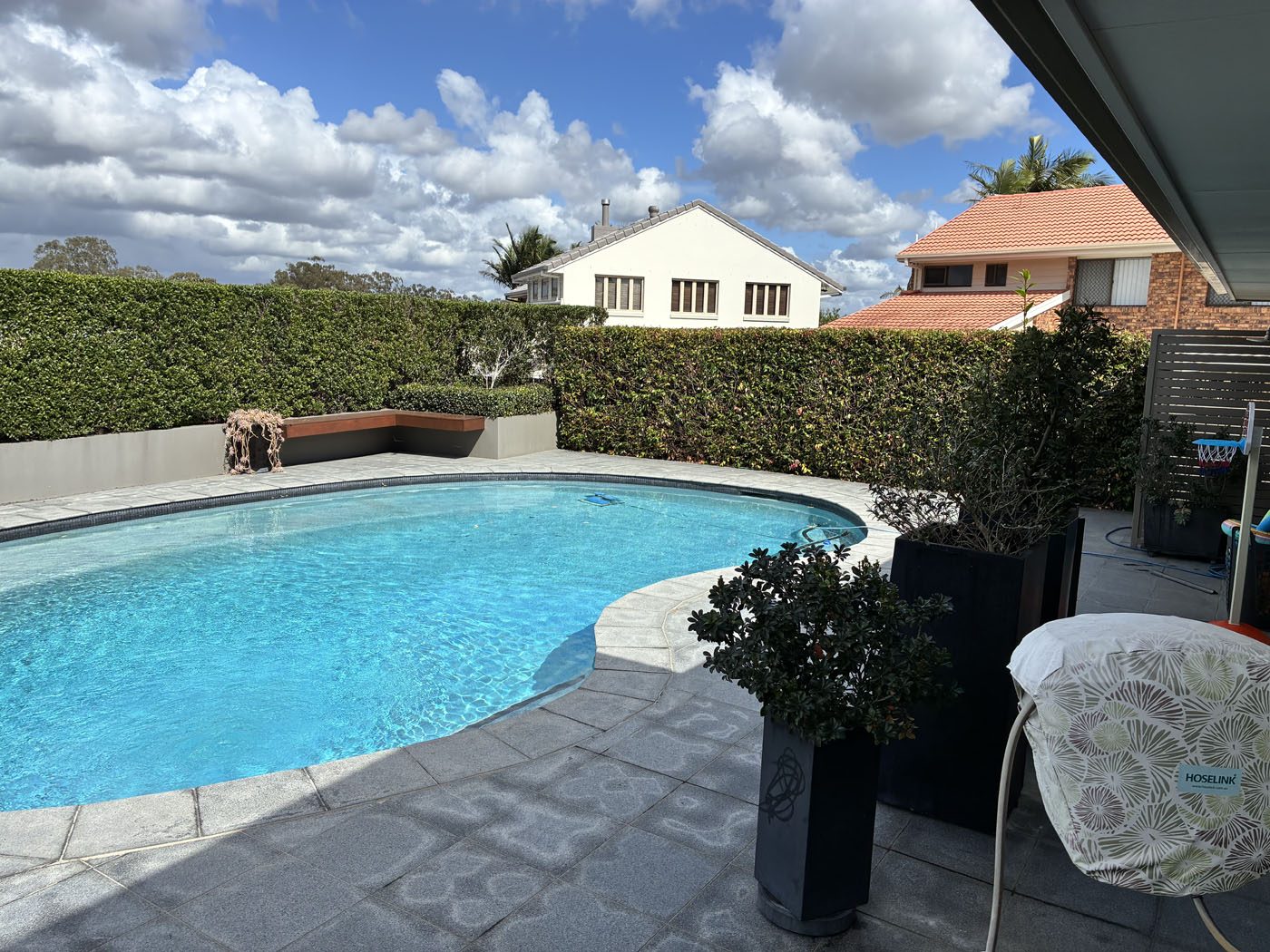Finished poolside garden area maintained by Haider Haiwary
